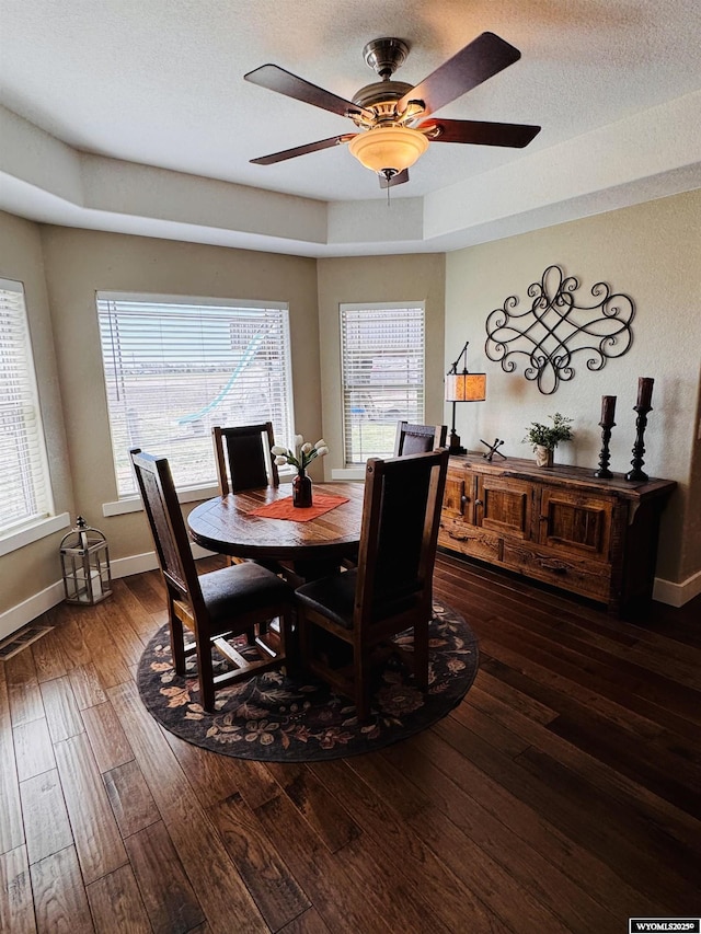 101 Pebble Ln, Torrington, WY 82240 - dining area featuring dark wood-type flooring, baseboards, and a ceiling fan