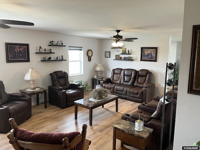 living room featuring ceiling fan and light wood finished floors