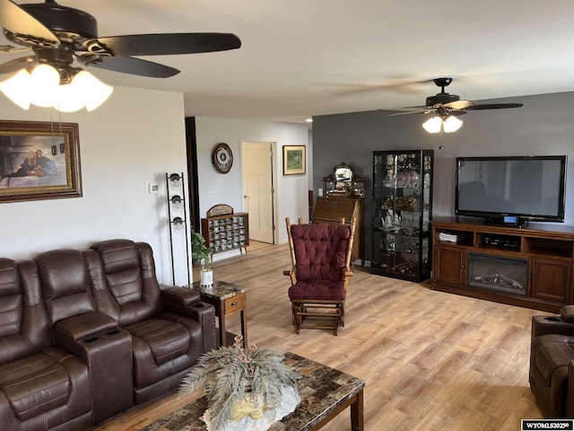 living area with a ceiling fan and light wood finished floors