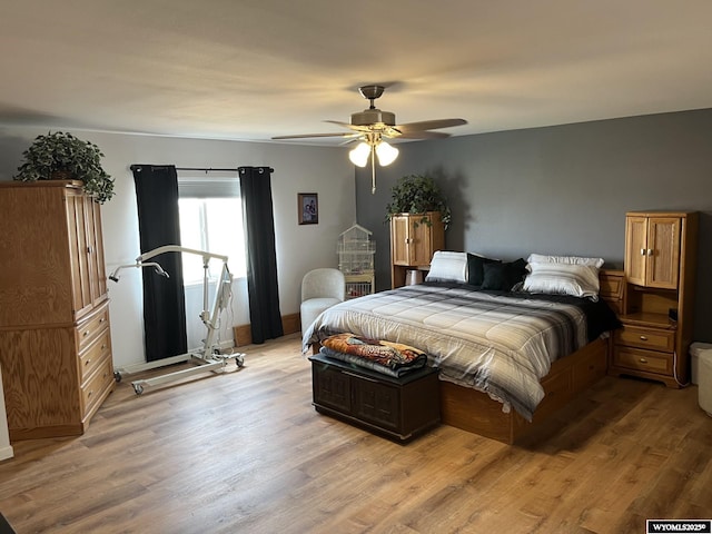 bedroom featuring light wood-type flooring, a ceiling fan, and baseboards