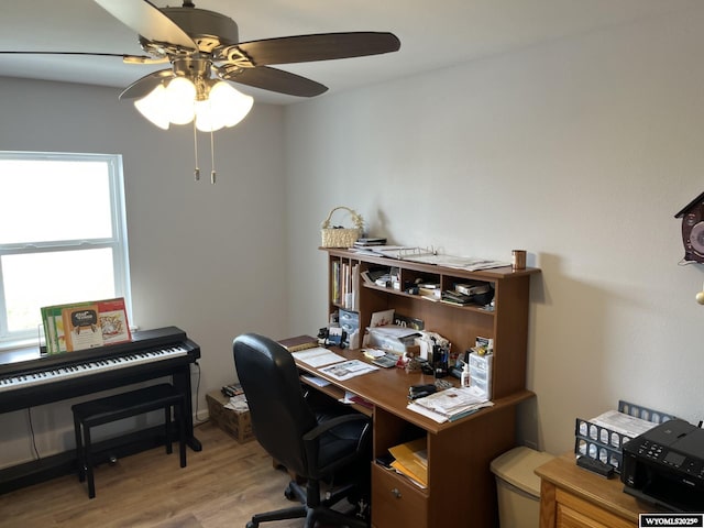 home office with ceiling fan and light wood-style flooring