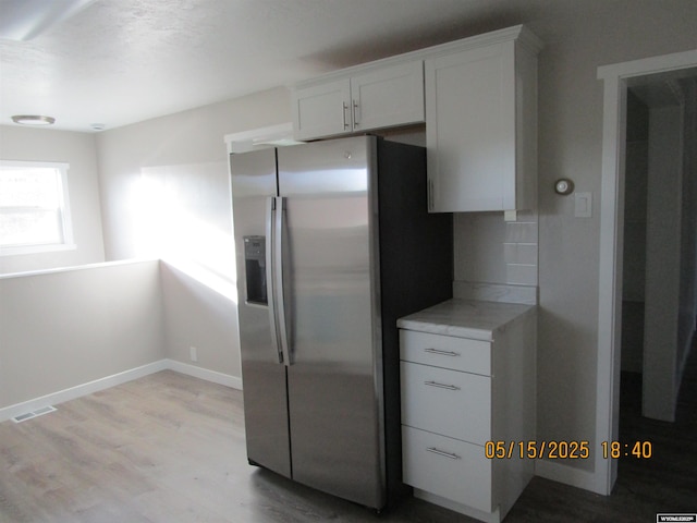 263 N 2nd Street E, St, Green River, WY 82935 - kitchen featuring stainless steel fridge with ice dispenser, light wood-style flooring, white cabinets, and baseboards
