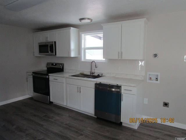263 N 2nd Street E, St, Green River, WY 82935 - kitchen with appliances with stainless steel finishes, a sink, dark wood-style floors, and white cabinetry