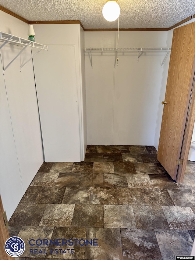 spacious closet featuring stone finish flooring