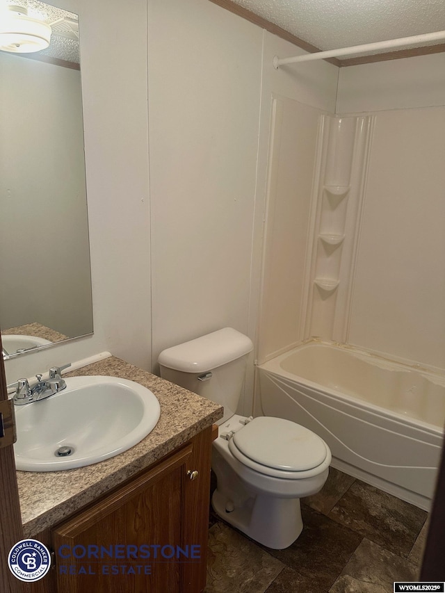 full bathroom featuring vanity, toilet, a textured ceiling, washtub / shower combination, and stone finish flooring