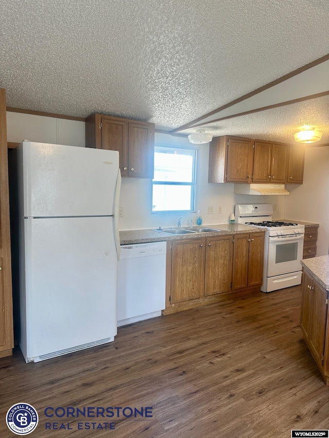 kitchen with white appliances, a textured ceiling, a sink, dark wood-type flooring, and brown cabinets