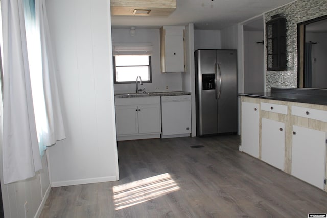 7 N Schmid Dr, La Barge, WY 83123 - kitchen featuring stainless steel refrigerator with ice dispenser, dishwasher, a sink, wood finished floors, and white cabinetry