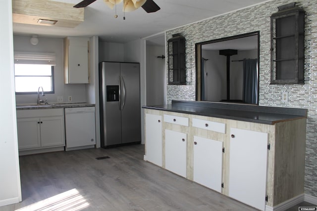 7 N Schmid Dr, La Barge, WY 83123 - kitchen featuring dishwasher, stainless steel refrigerator with ice dispenser, a sink, a ceiling fan, and dark countertops