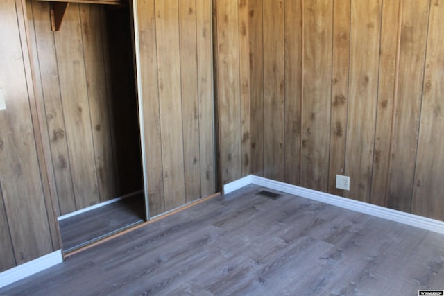 7 N Schmid Dr, La Barge, WY 83123 - empty room with wood finished floors, baseboards, and wood walls