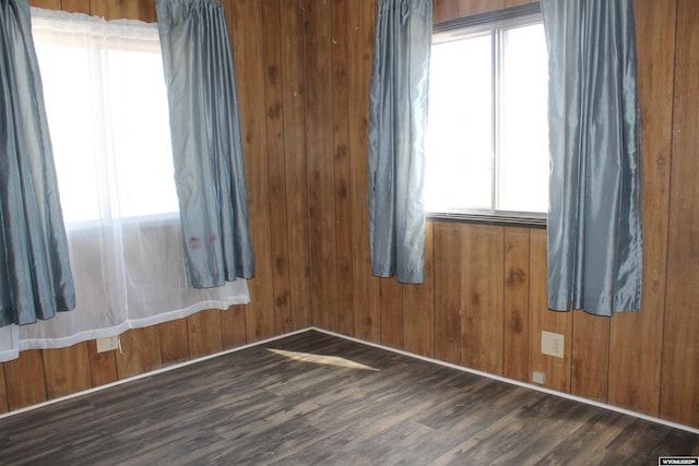 7 N Schmid Dr, La Barge, WY 83123 - unfurnished room with plenty of natural light, dark wood finished floors, and wood walls
