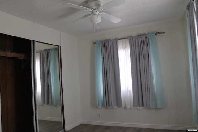 7 N Schmid Dr, La Barge, WY 83123 - unfurnished bedroom featuring wood finished floors, a closet, baseboards, and a ceiling fan