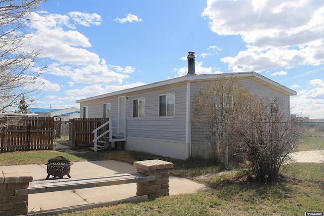 7 N Schmid Dr, La Barge, WY 83123 - back of property featuring fence, a fire pit, and a patio