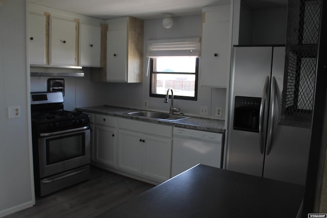 7 N Schmid Dr, La Barge, WY 83123 - kitchen with appliances with stainless steel finishes, a sink, under cabinet range hood, white cabinets, and dark wood finished floors