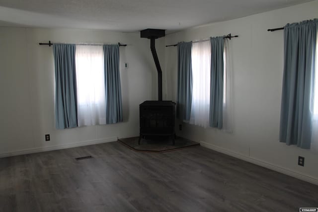7 N Schmid Dr, La Barge, WY 83123 - spare room featuring wood finished floors, plenty of natural light, and a wood stove