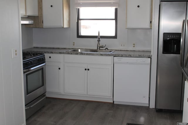 7 N Schmid Dr, La Barge, WY 83123 - kitchen featuring stainless steel appliances, a sink, wall chimney range hood, white cabinets, and wood finished floors