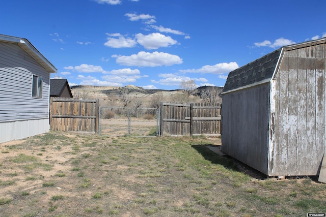 7 N Schmid Dr, La Barge, WY 83123 - view of yard featuring a shed, an outbuilding, a gate, and a mountain view