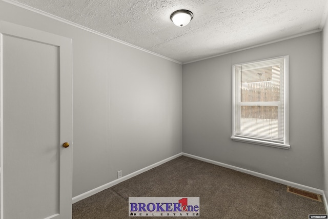 spare room featuring ornamental molding, carpet floors, a textured ceiling, and baseboards