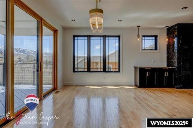 unfurnished living room with wood finished floors and baseboards