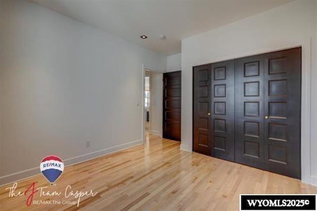 foyer entrance with wood finished floors and baseboards