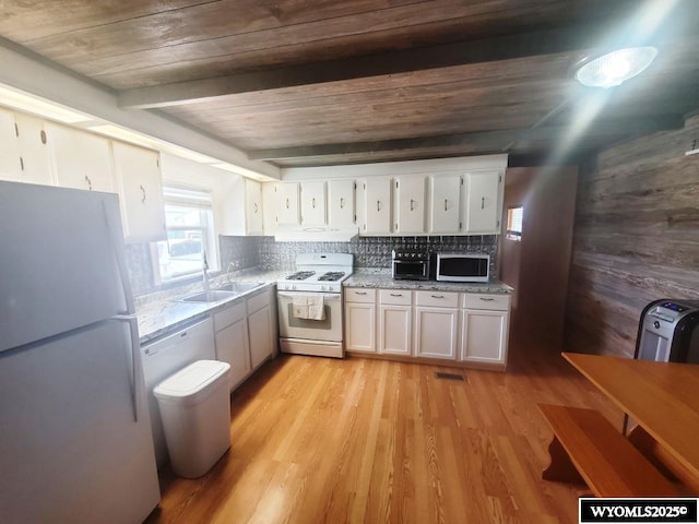 kitchen featuring white appliances, wooden ceiling, a sink, white cabinets, and tasteful backsplash