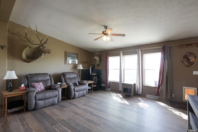 33 Oxbow Rd, Buffalo, WY 82834 - living area with a wood stove, hardwood / wood-style floors, ceiling fan, a textured ceiling, and vaulted ceiling