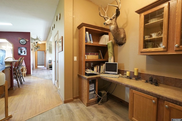33 Oxbow Rd, Buffalo, WY 82834 - home office featuring light wood-style floors, built in study area, baseboards, and a chandelier