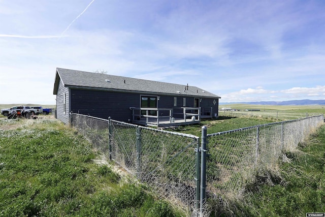33 Oxbow Rd, Buffalo, WY 82834 - rear view of house with a wooden deck and a shingled roof