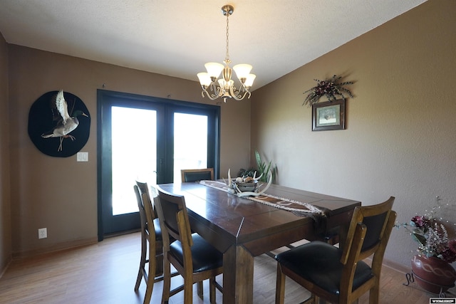 33 Oxbow Rd, Buffalo, WY 82834 - dining space featuring a chandelier, light wood-type flooring, baseboards, and french doors