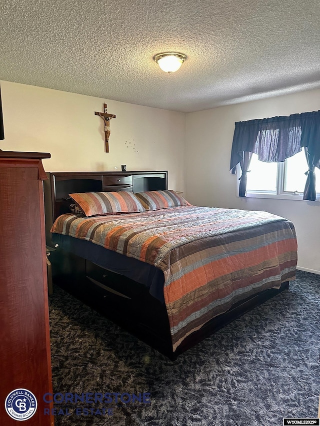 bedroom featuring carpet floors and a textured ceiling