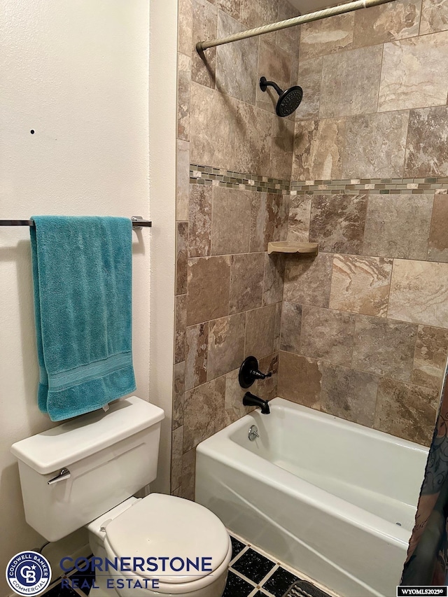 bathroom featuring toilet and shower / bath combination with curtain