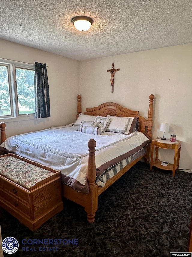 carpeted bedroom featuring a textured ceiling