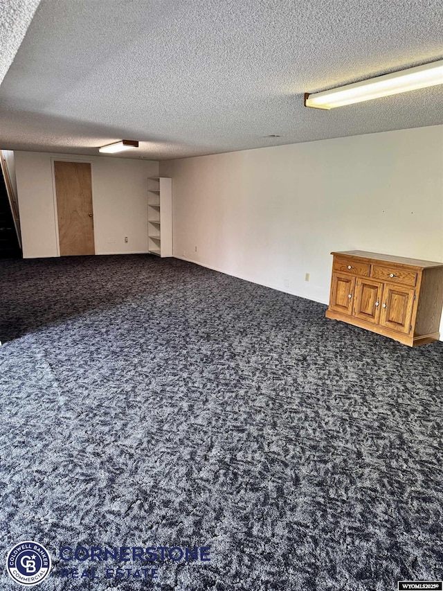 finished basement featuring carpet and a textured ceiling