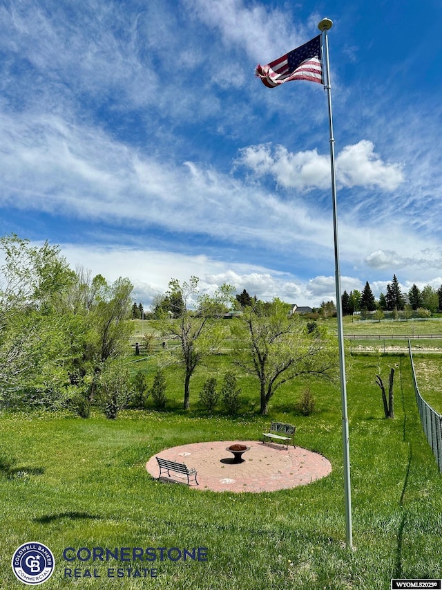 view of property's community with a fire pit and a view of countryside