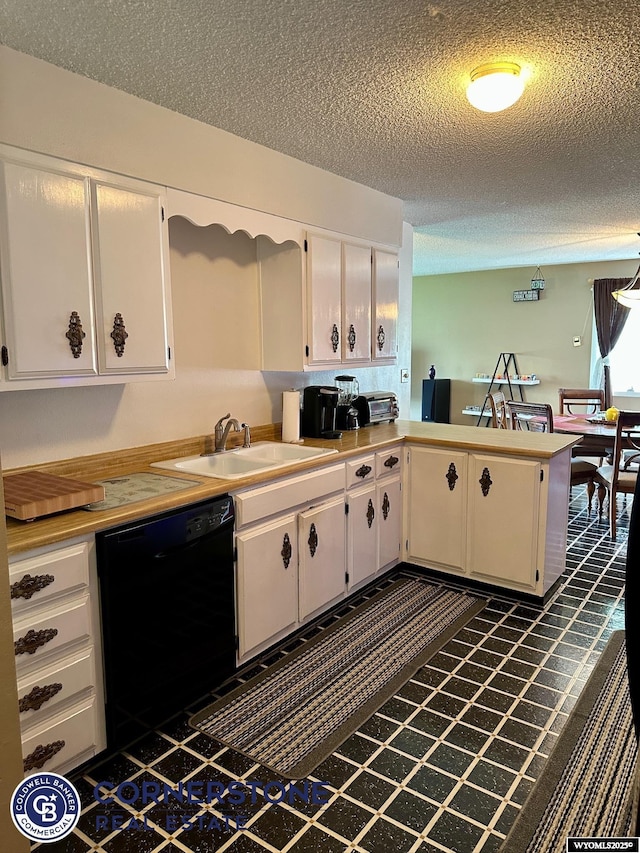 kitchen with dishwasher, a sink, white cabinets, and a textured ceiling