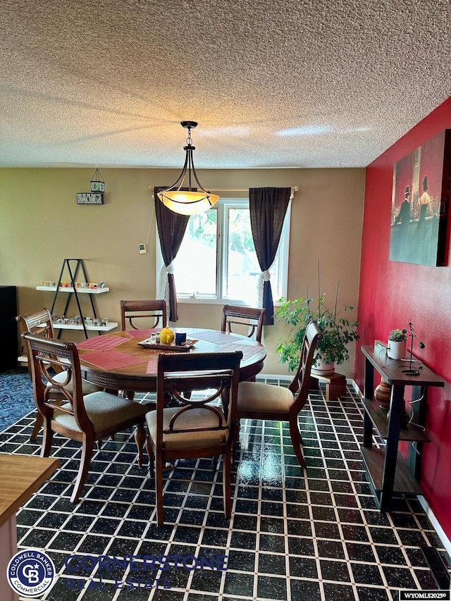 dining space featuring a textured ceiling
