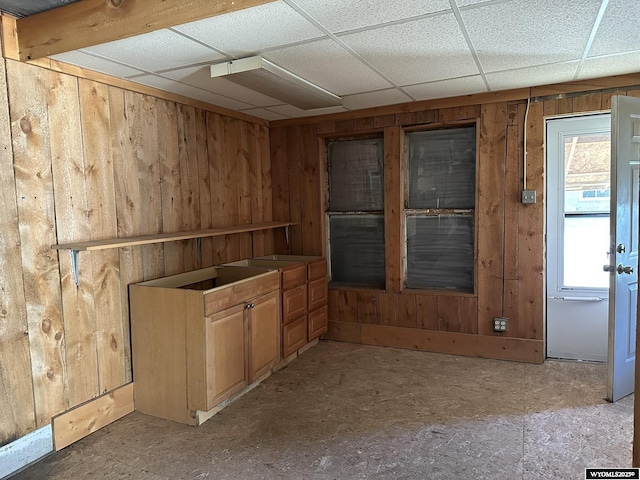 107 S Laramie Ave, Fort Laramie, WY 82212 - kitchen featuring wooden walls and a paneled ceiling