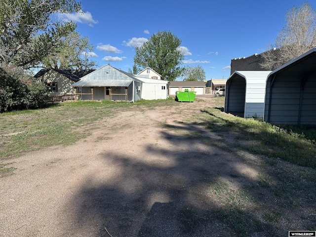 107 S Laramie Ave, Fort Laramie, WY 82212 - view of yard featuring driveway and a carport