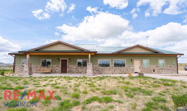 6 Chapparal, Douglas, WY 82633 - view of front of home with stone siding and a porch