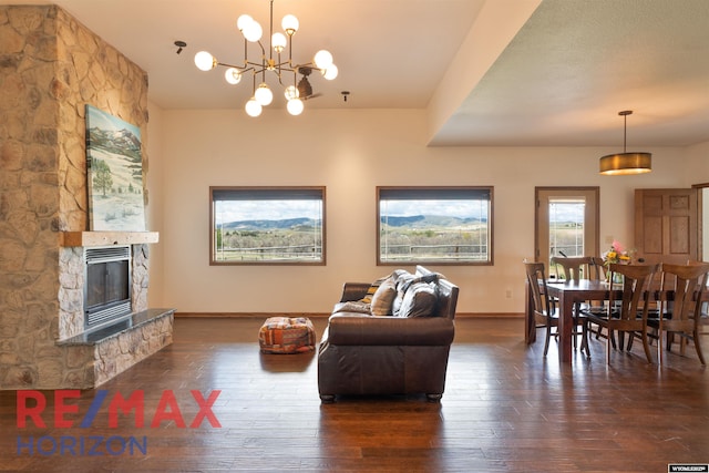 6 Chapparal, Douglas, WY 82633 - living area with hardwood / wood-style floors, baseboards, a chandelier, and a stone fireplace