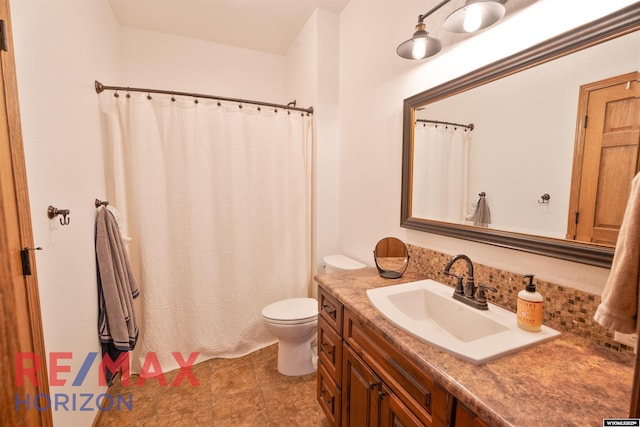 6 Chapparal, Douglas, WY 82633 - full bath featuring toilet, vanity, backsplash, and curtained shower
