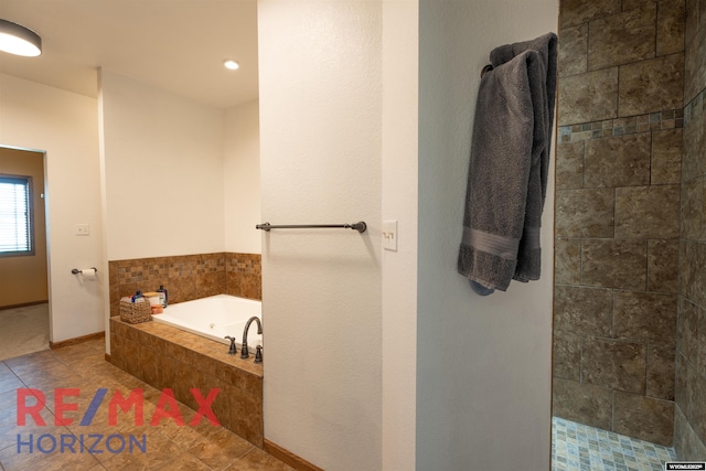 6 Chapparal, Douglas, WY 82633 - full bathroom featuring a garden tub, tile patterned floors, tiled shower, and baseboards