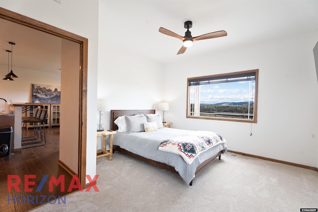 6 Chapparal, Douglas, WY 82633 - bedroom featuring baseboards, ceiling fan, carpet floors, and wood finished floors