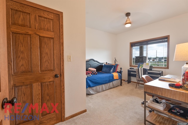 6 Chapparal, Douglas, WY 82633 - bedroom with light carpet, a desk, ceiling fan, and baseboards