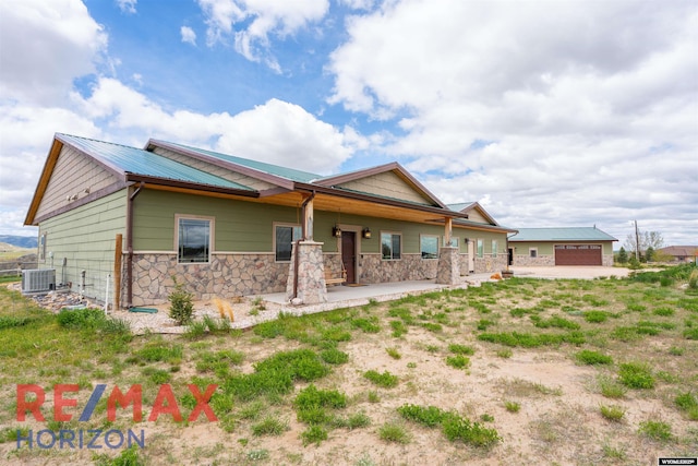 6 Chapparal, Douglas, WY 82633 - back of property with stone siding, central air condition unit, a porch, and metal roof