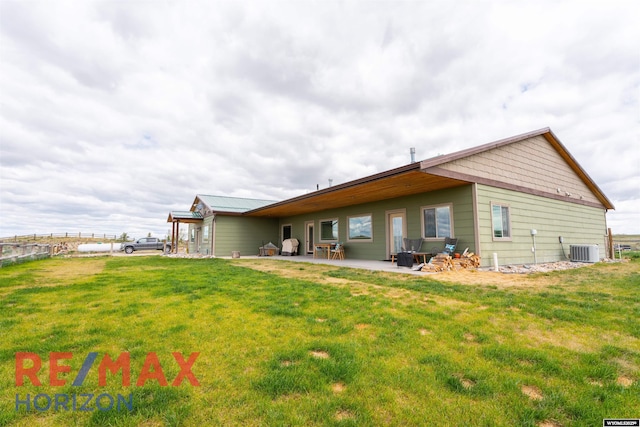 6 Chapparal, Douglas, WY 82633 - rear view of house with central AC, a lawn, and a patio area