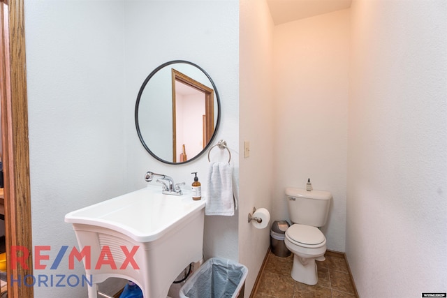 6 Chapparal, Douglas, WY 82633 - half bath featuring toilet, baseboards, and a sink