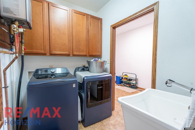 6 Chapparal, Douglas, WY 82633 - washroom featuring water heater, separate washer and dryer, and cabinet space