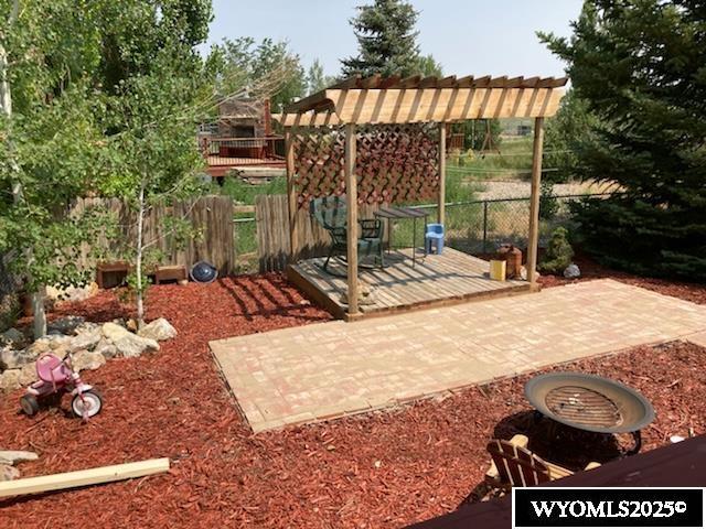 view of patio featuring a pergola and fence