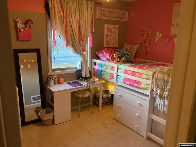 bedroom with carpet floors and a desk