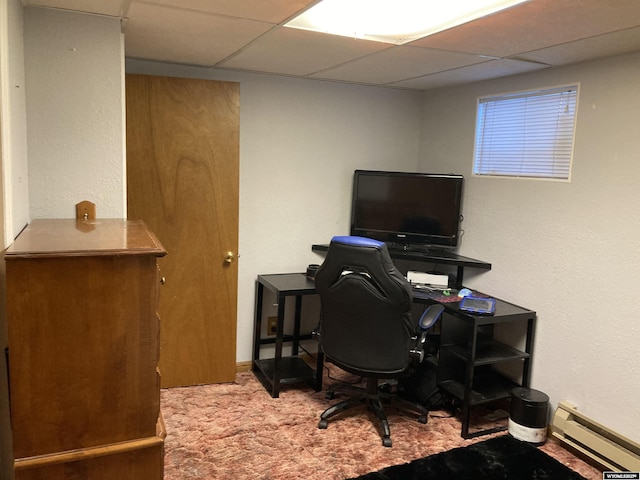 carpeted office space with a baseboard radiator and a paneled ceiling